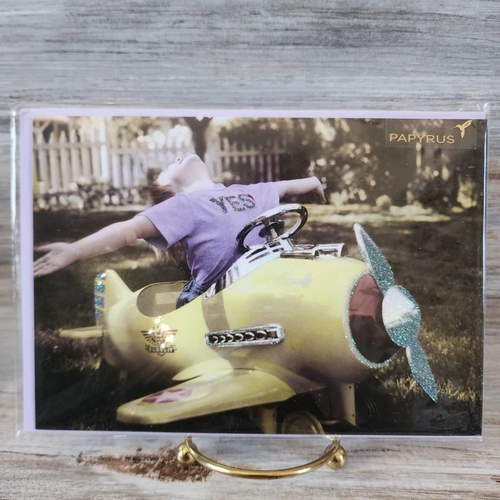Papyrus Blank Greeting Card Gail Goodwin Child in Yellow Pedal Plane Glitter